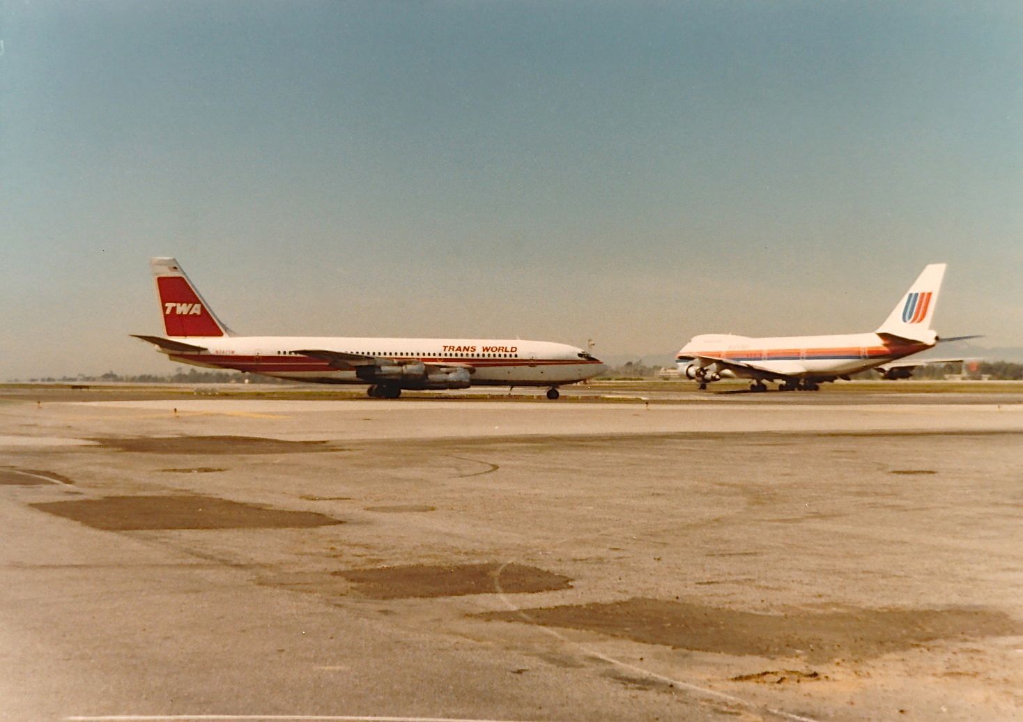 Boeing 707-100 — - TWA B-707 ready for take off with a United B-747 on take off roll in the back ground at KLAX spring 1977