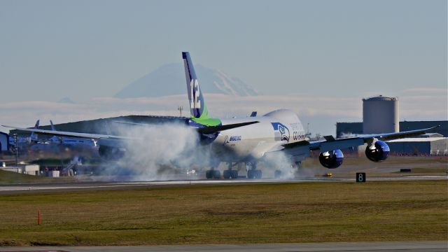 BOEING 747-8 (N770BA) - BOE12 makes tire smoke on landing Rwy 16R on 2/5/14. (LN:1437 cn 37564).