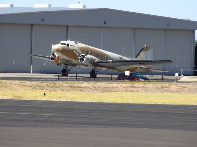 Douglas DC-3 (N147AZ) - Seen from the Falcon Warbirds hanger at Falcon Field.