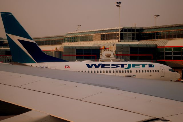 Boeing 737-800 (C-GWSI) - Pushing back from Gate C30 at Terminal 3 at YYZ (Toronto Pearson). On board Air Transat TSC TS224, an A333.    You can see the West Jet 737 in the background.