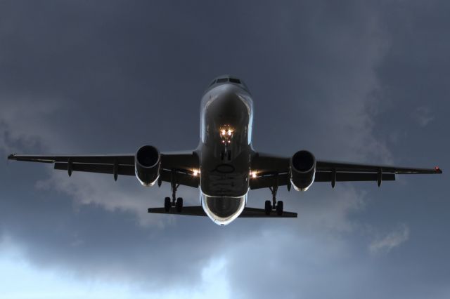 — — - Ominous clouds greet the arrival of this QATAR A320-200.