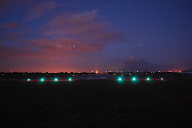 — — - FYI, we did not land short. This is a shot after sunset at La Porte Airport of runway 05, with a beautiful, colorful sky. Look down past the runway, and you will see the Baytown Bridge lit up just to the left of the runway centerline. Can't find La Porte? Get over the bridge and head 230.