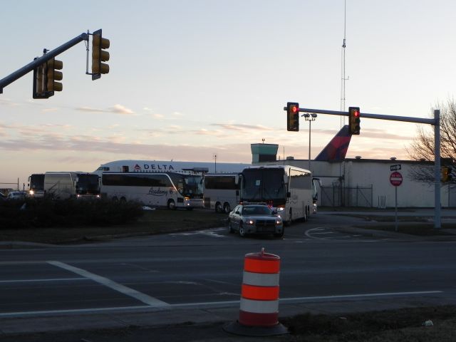 BOEING 767-300 (N138DL) - Buses with the Baltimore Ravens head to Foxboro as N138DL sits in the background