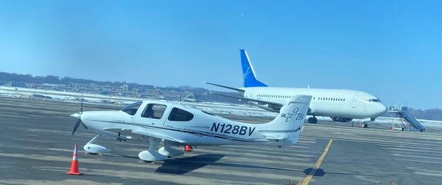 Cirrus SR-22 (N128BV) - At Wisconsin Aviation on private aircraft side of Truax Field. No id on Boeing 737-couldn't make out registration. Charter?