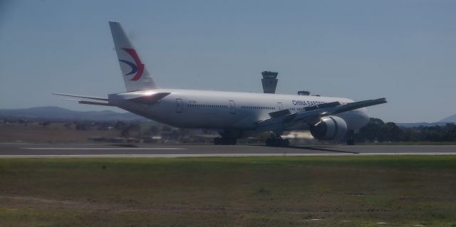 Boeing 777-200 (B-7368) - Touchdown incoming from Shanghai - taken from aircraft waiting to use the runway for takeoff