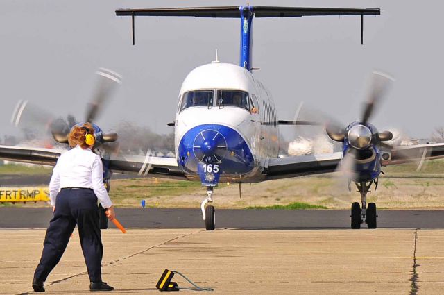 Beechcraft 1900 (N165YV) - What is the pilot pointing to?