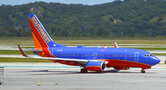 Boeing 737-700 (N7750A) - Southwest 2103 is departing for St. Louis at 2:07 PM CDT at Omaha Eppley Airfield on July 27, 2018.   Photo taken with Nikon D3200 mounting 55-200mm VR lens.