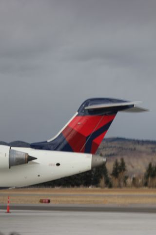 Canadair Regional Jet CRJ-700 (N713EV) - N713EV at Butte after landing from KSLC as SKYWEST 4312. Engines just turned off, with the APU on with the Berkeley Pit behind it.br /br /Taken 17:04, November 2, 2024 with a Canon EOS T2i and 70-300mm (115mm, 1/200, ƒ4.5, ISO 100)