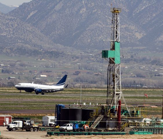 — — - A Boeing 737 business jet lifts off from Garfield County Regional airport in Rifle, Colorado in 2008 photo at the height of gas drilling in the area.