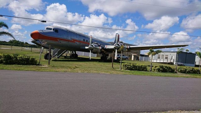 Douglas DC-7 (N381AA) - A classic DC-7 resting outside of New Smyrna Municipal Airport