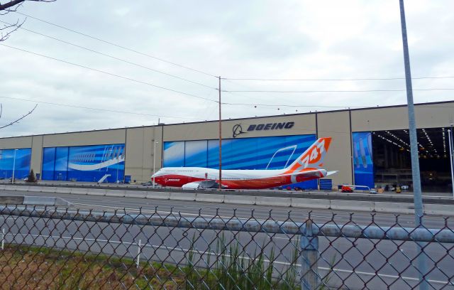 N6067E — - ROLL OUT SERIES #7:  Boeing 747-8 Intercontinental RC001 Business Jet for undisclosed government  customer being pulled over to the Boeing Freeway (highway 526) cross-over bridge on 2-13-2011 roll-out day at Paine Field, Everett, Washington  ||||   Photo by Bruce McKinnon