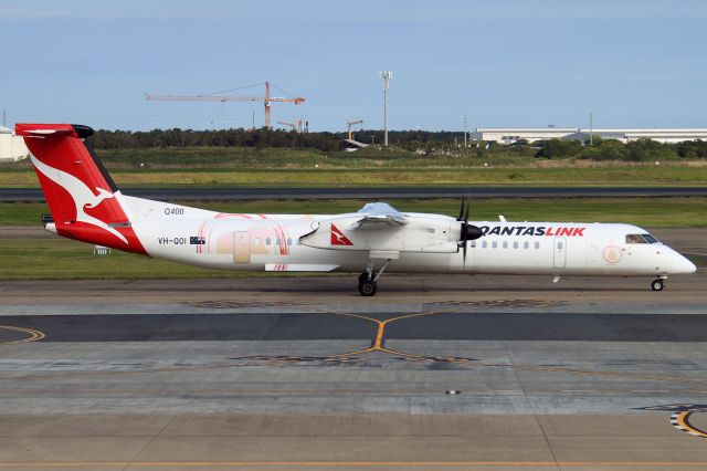 de Havilland Dash 8-400 (VH-QOI) - Taken thru the glass of the departures lounge