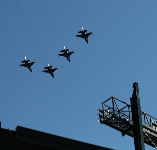 — — - Standing outside Lambeau Field, four Madison, WI based F-16C's perform a flyover.