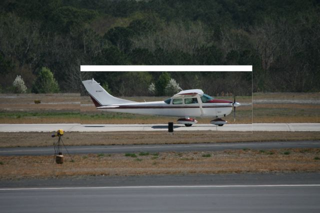 Cessna Skylane (N3196Y) - Quiet landing at KPDK.  Photo taken from the viewing area set up for the public