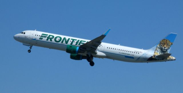 Airbus A321 (N712FR) - Shortly after departure is this 2016 Frontier Airlines Airbus A321-211 with "Spot" the Jaguar looking on in the Spring of 2021.