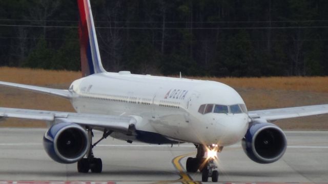 Boeing 757-200 (N648DL) - Turning off runway 5L.