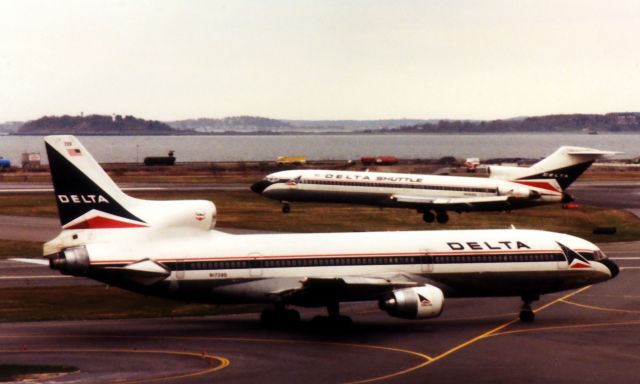 Lockheed L-1011 TriStar (N1739D) - Delta L1011 departing Boston Logan while a Delta Shuttle B727-200 lands in back in the late 1990's. 