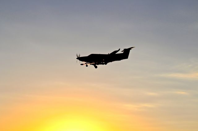 Pilatus PC-12 — - PC12 on short final for runway 13 at KRVS, beautiful sunset