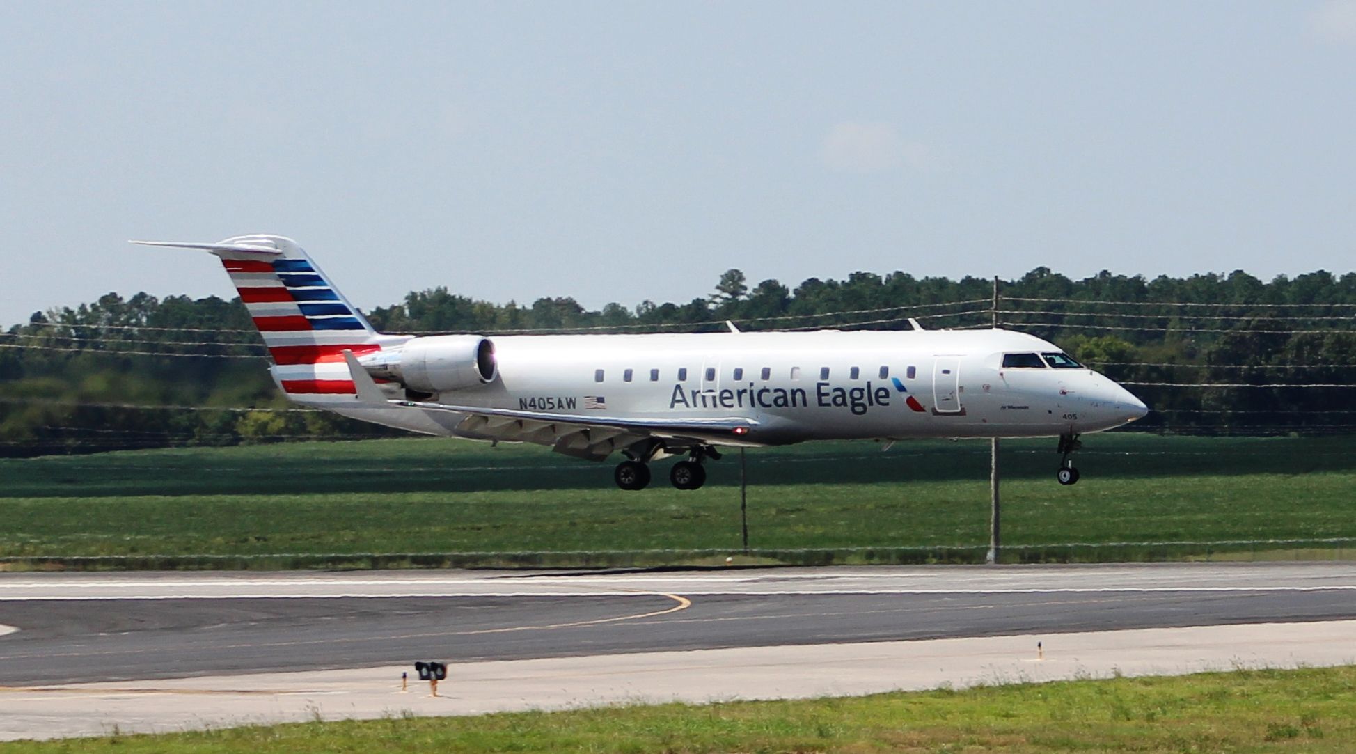 Canadair Regional Jet CRJ-200 (N405AW) - A Bombardier CRJ 200 about to land on Runway 36L at Jones Field, Huntsville International, AL on September 2, 2016. Shot with a Canon T5 in sports mode using a 75mm-300mm lens from over the top of the airport perimeter fence along taxiway beside the west Boeing road.