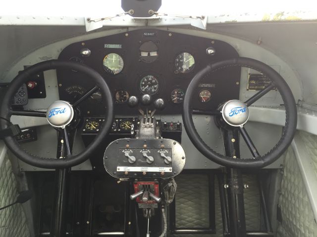 — — - EAAs Ford Tri-Motor.  Cockpit, love the Model T steering wheels.