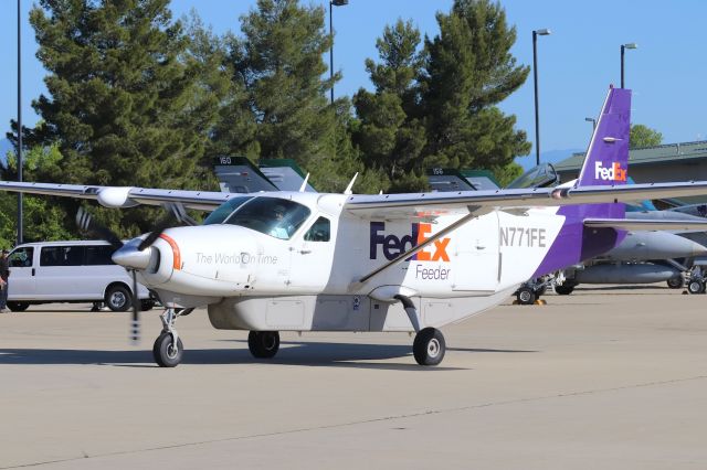 Cessna Caravan (N771FE) - KRDD April 21st, 2018 FedEx 208 Caravan arriving at the FedEx ramp at Redding from KSMF. The daily flight was 1st in this day on a busy ramp with the Sharpshooters of VMFAT-101 F/A-18 out of MCAS Miramar in town for training flights. Ship 160 behind the FedEx package express had a flat tire and the air-crew mechanics are shown in the background after repairs were completed.