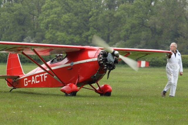 G-ACTF — - A wing walker (a human tiller of sorts) guides another vintage aircraft from the Shuttleworth Collection out to the grass runway ready to take part in the flight display.