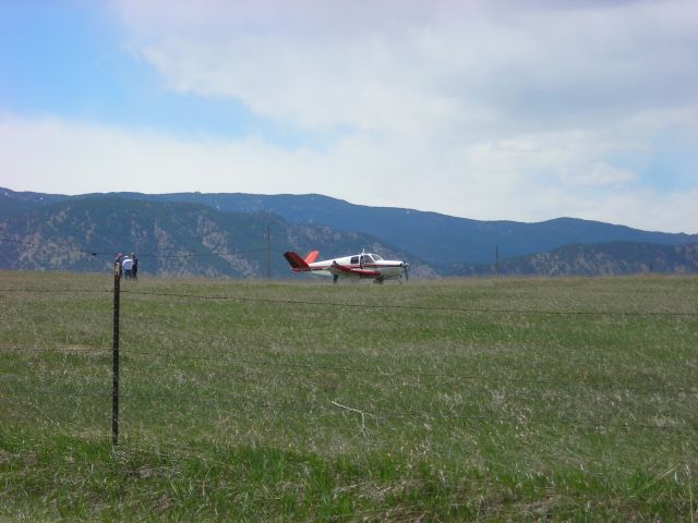 Beechcraft 35 Bonanza (N8SM) - damaged plane in field ... you can see that the right wing is damaged from going through the fence (possibly) to come to rest in this field.