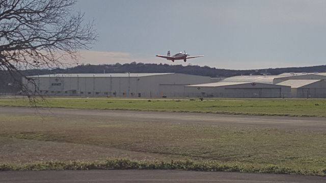 Mooney M-20 (N6830N) - A Mooney taking off in front of the Mooney plant in Kerrville Texas