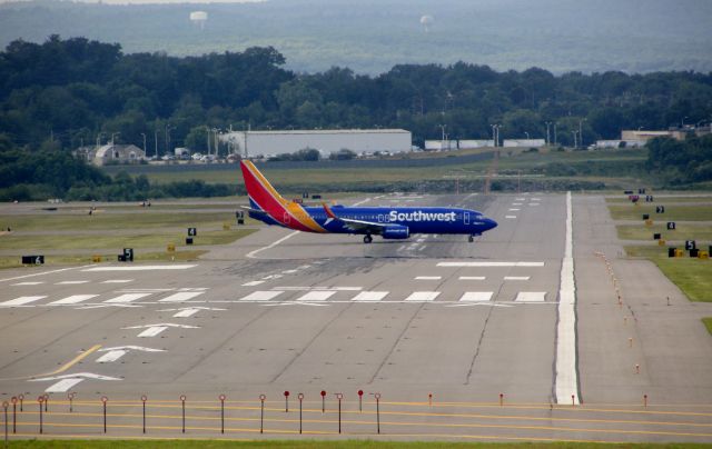 Boeing 737-800 (N8642E) - Heart One taxiing to RW24 at KMHT; crossing RW35.