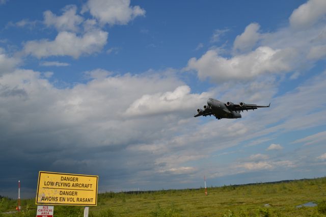 Boeing Globemaster III (N1190) - A C-17 lands at runway 31 at Gander International as a Thunderstorm passes nearby.