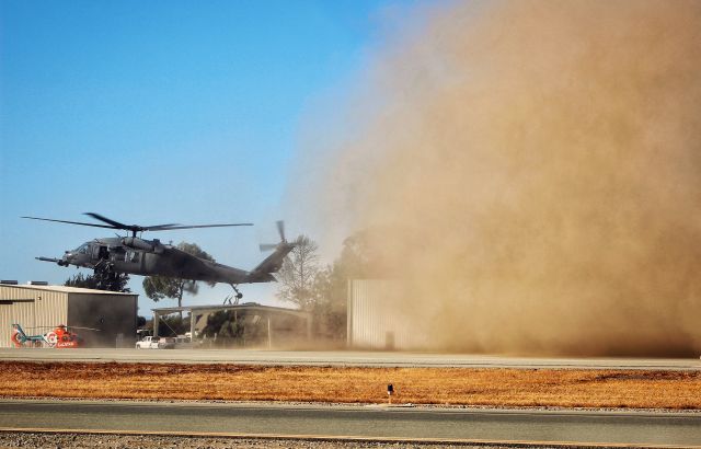 8826107 — - (88-26107) Departing off the ramp with a cloud of dust trailing behind.