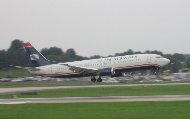 BOEING 737-400 (N409US) - Arriving on runway 18C - 6/17/09