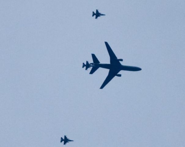 — — - A USAF KC-10 Extender refueling an F-16 while flanked by two more F-16s as seen from the DeSoto National Forest on January 23, 2010.