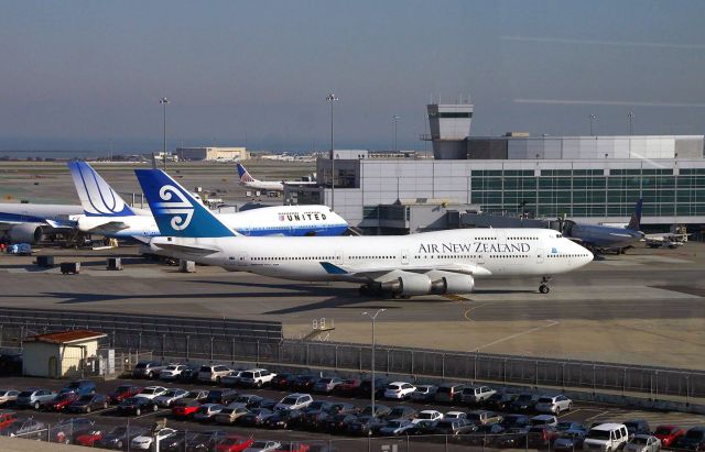 Boeing 747-400 (ZK-SUH) - KSFO - Air New Zealand -400 rolling past the UAL 747 at Intl Terminal G - so cool to ride the Tram and see all of the 747 Globetrotters at the Airport. The ANA 777-300R nosed in next to United - showing its toughness vs the 747. Date Feb 1 2013.