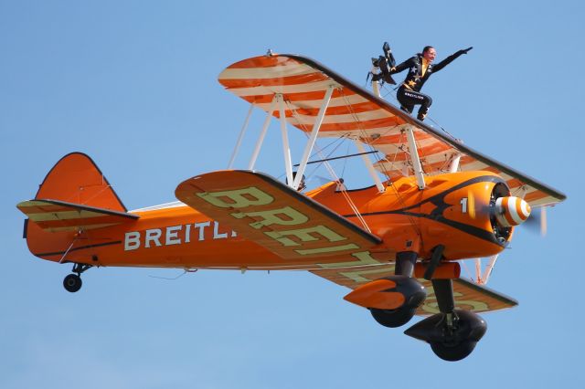 — — - Flypast of a Breitling, Boeing PT-17 Stearman with Wingwalker.