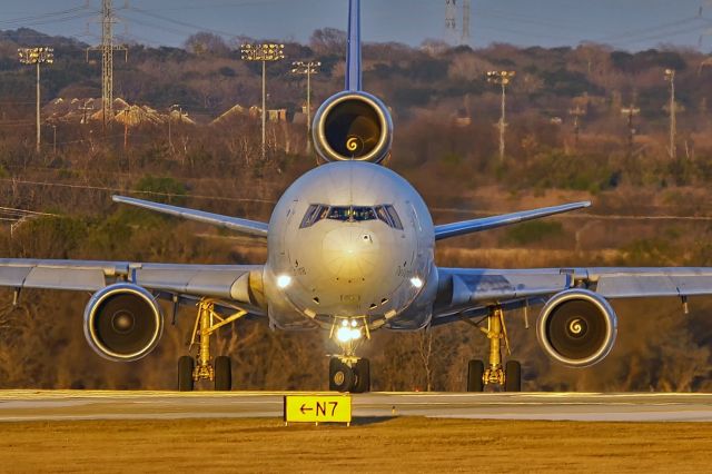 Boeing MD-11 (N609FE) - Turning onto 22 for departure just before sunset.