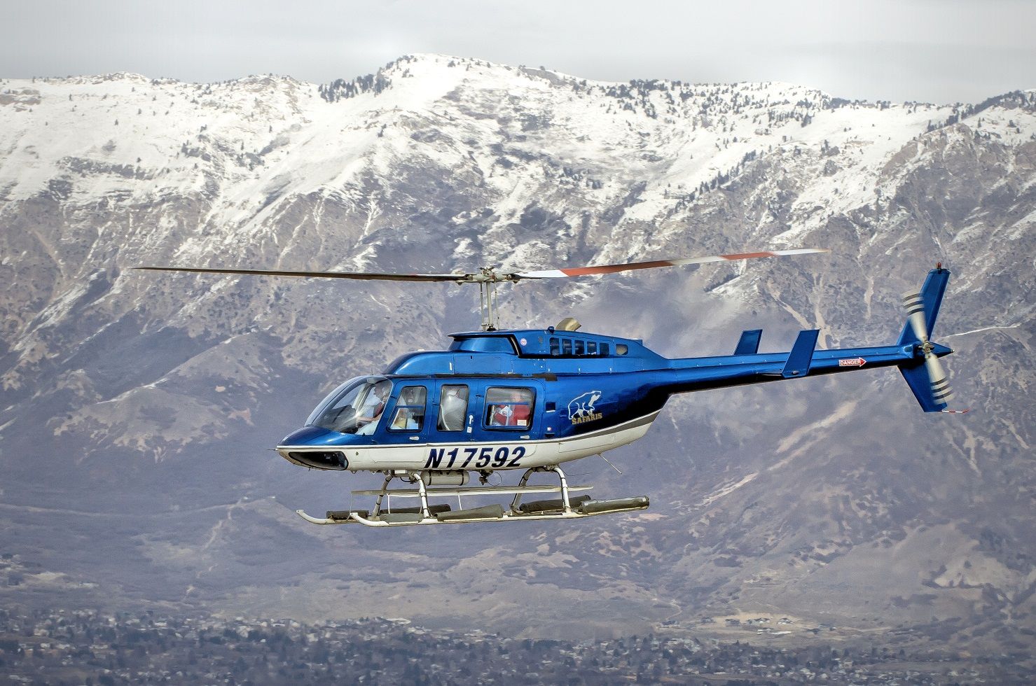 Bell JetRanger (N17592) - Groom at the controls with Bride as the copilot in a helicopter full of wedding party folks leaving Ogden-Hinckley airport. This helicopter returned a few times picking up folks for the wedding. Helicopter operated by Alaska Ultimate Safari. I believe the Owners are the ones getting hitched.