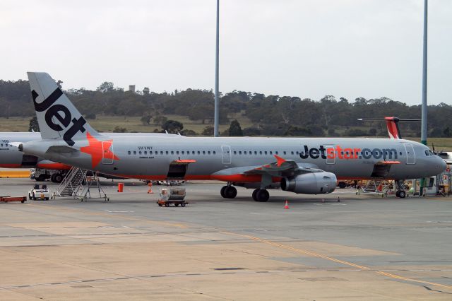 Airbus A321 (VH-VWY) - Taken thru the glass of the deaprtures lounge