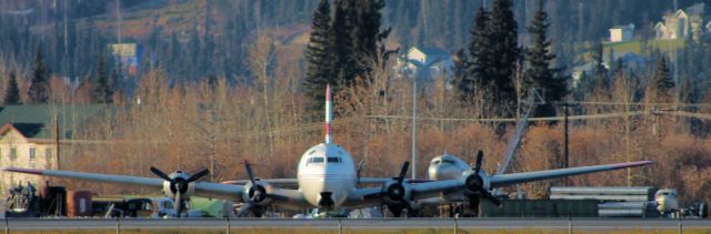 — — - C-54 with a C-47 and a Beech 18 of which the last 2 may never fly again.