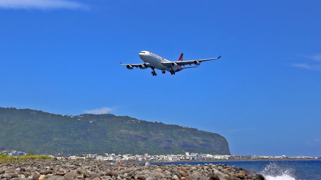 Airbus A340-300 (3B-NBE) - Approaching the runway above the see.