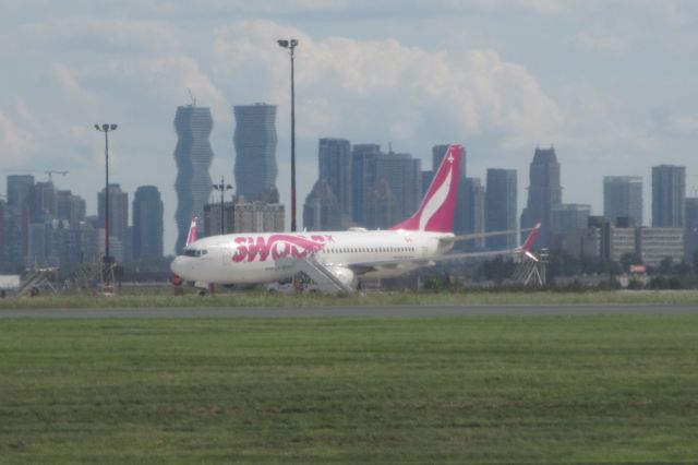 Boeing 737 MAX 8 (C-GORP) - Swoop Airlines 737 MAX parked for maintenance at Toronto Pearson with Toronto in the background