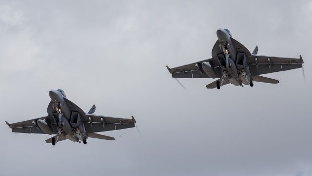 McDonnell Douglas FA-18 Hornet — - First and only time, so far, I was fortunate enough to witness a formation approach and landing by 2 RAAF Super Hornets. This formation threw me in terms of lens choice. I saw the 2 off in the distance and decided to stick with the 200m Prime unfortunately as the aircraft got closer I realised I was in the right position for 2 shots only, this one ...