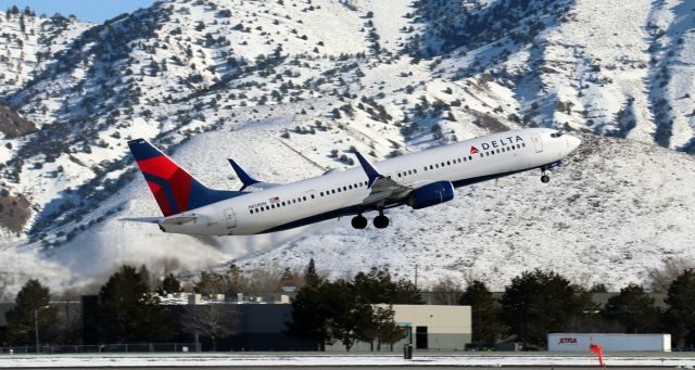 Boeing 737-900 (N828DN) - Off 17L and on the climb to Salt Lake City (KSLC).