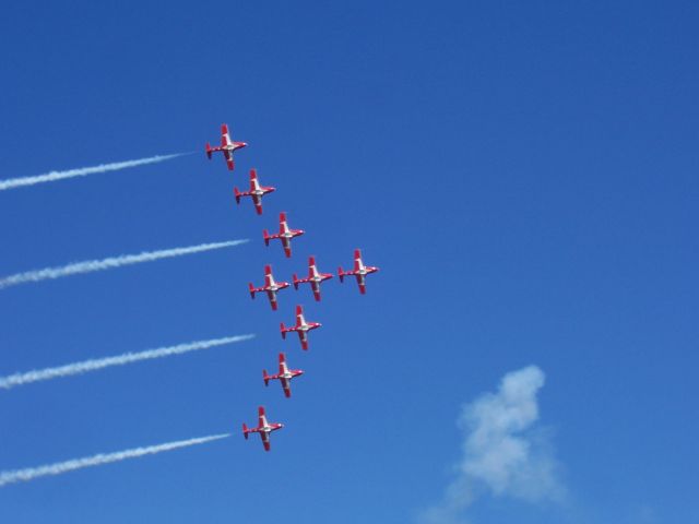 — — - 9 Canadair CT-114 Tutors  Canadian Snowbirds fly the  "Vulcan Formation"