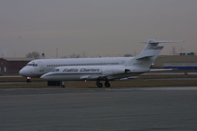 N70CX — - Falcon taxiing to Runway 30 while the MD-80 holds short on taxiway "A" at Gary Regional Airport.  Photo was taken 12/6/2013.