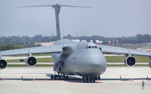 — — - C5 parked at the cargo ramp at Nashville. Notice the guy in front of the aircraft taking a picture.