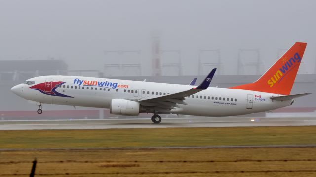 Boeing 737-800 (C-FGVK) - Taking off in dense fog for sunnier destination.