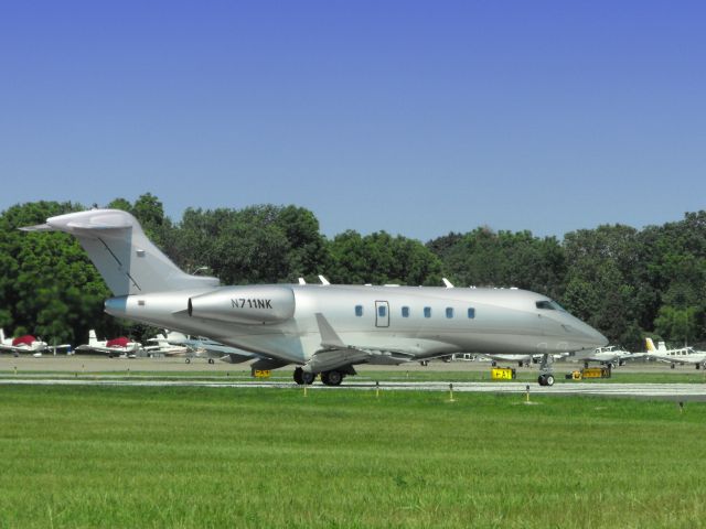 Bombardier Challenger 300 (N711NK) - Shown here in the Spring of 2012 this Super Size Business Jet can handle up to 16 passengers while transversing the Continent at 540 MPH.  This Jet is seconds from deparature on this VFR day.