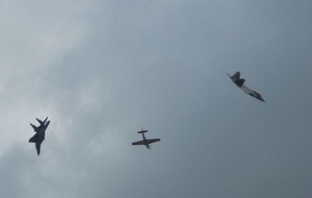 — — - F-22, P-51 and F-15 break following Heritage Flight over Charleston AFB