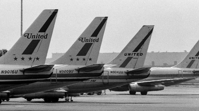 Boeing 737-700 (N9009U) - Two older United Airlines logos and liveries on four B737 tails at Cleveland Hopkins Airport in the late 1960s